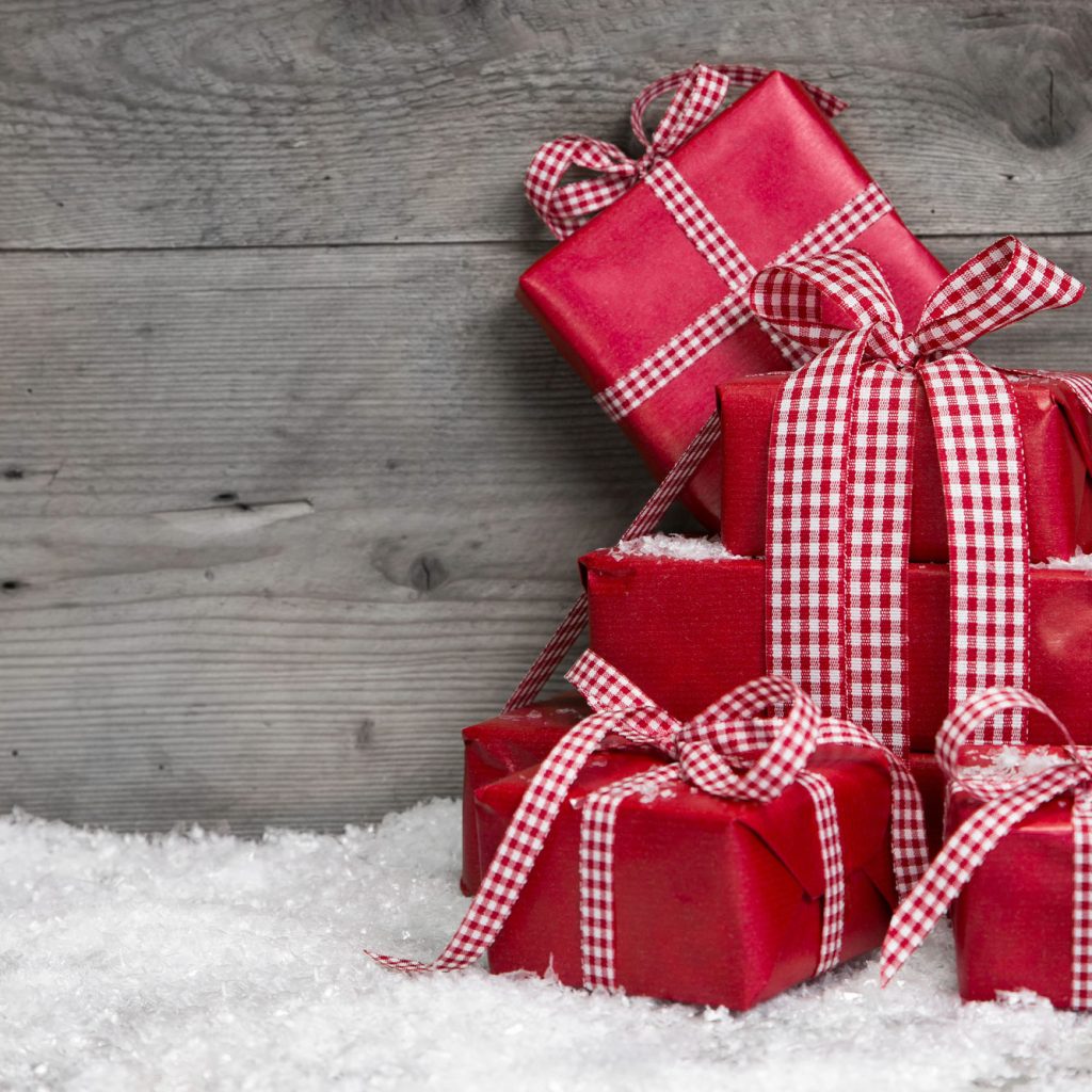 red Christmas gifts stacked up on fake snow